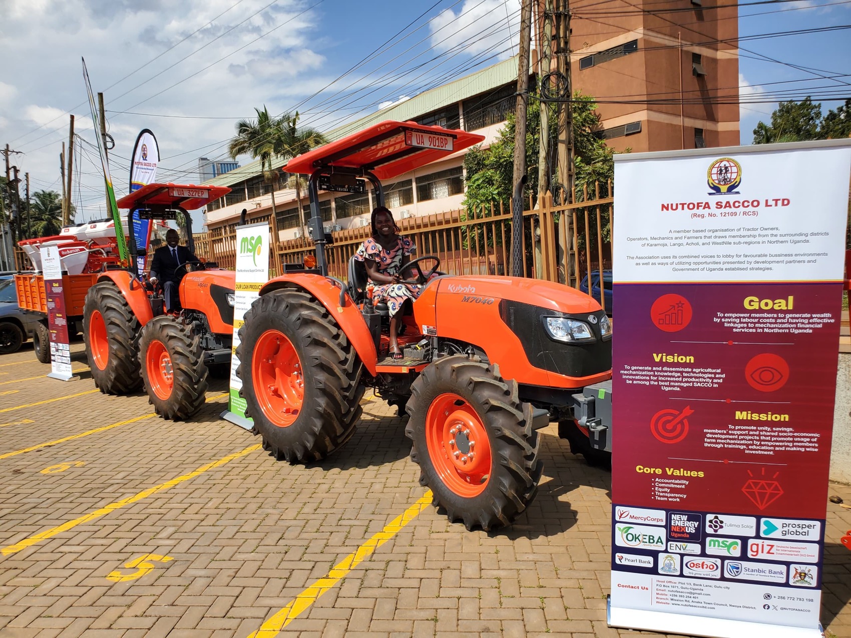 The three new Kubota tractors with the NUTOFA banner at the handover